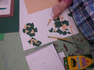 Heidi starting to arrange the torn pieces of paper to make her mountains.